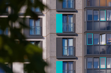 Texture of modern buildings, background for design. Elements of architectural decorations of buildings, modern windows, walls and balconies.の写真素材