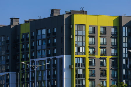 Cityscape on a summer day, modern buildings and houses against the blue skyの写真素材