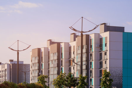 Cityscape on a summer day, modern buildings and houses against the blue skyの写真素材