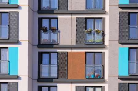 City view on a sunny day. Modern building and houses against the blue sky.