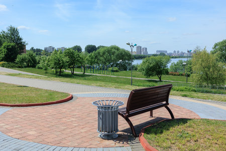 Wooden benches and chaise lounges for rest on the streets of the city and in the park, public placesの写真素材