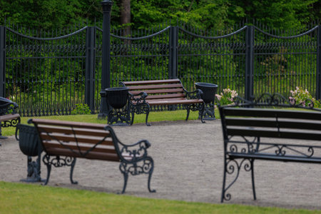 Wooden benches and chaise lounges for rest on the streets of the city and in the park, public placesの写真素材