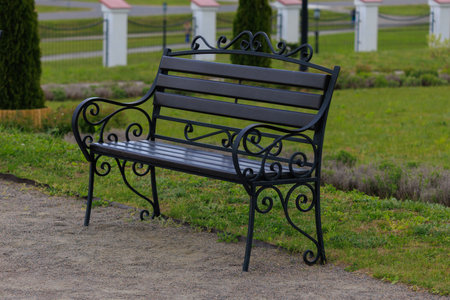 Metal benches for rest on the streets of the city and in the park, public placesの写真素材