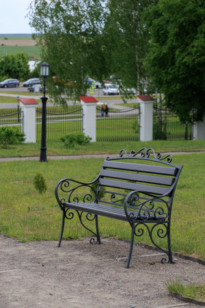 Wooden benches and chaise lounges for rest on the streets of the city and in the park, public placesの写真素材