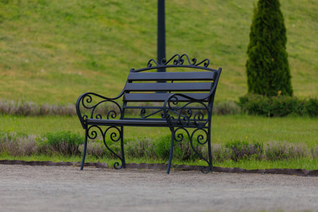 Wooden benches and chaise lounges for rest on the streets of the city and in the park, public placesの写真素材