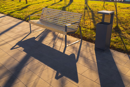 Wooden benches and chaise lounges for rest on the streets of the city and in the park, public placesの写真素材