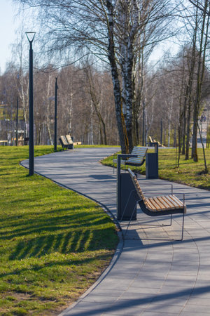 Wooden benches and chaise lounges for rest on the streets of the city and in the park, public placesの写真素材