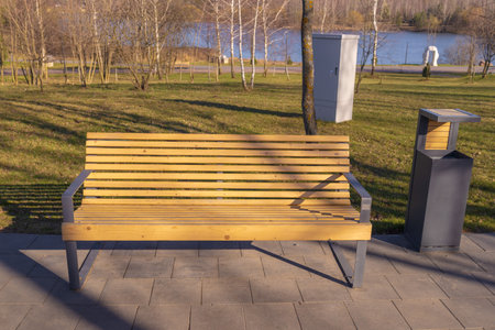 Wooden benches and chaise lounges for rest on the streets of the city and in the park, public placesの写真素材