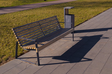 Wooden benches and chaise lounges for rest on the streets of the city and in the park, public placesの写真素材