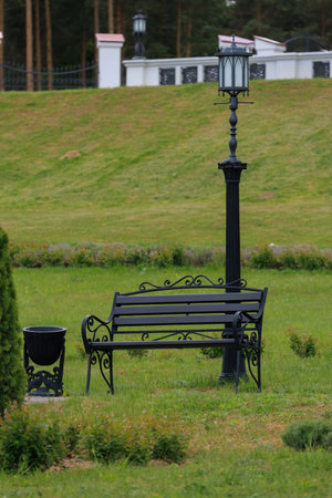 Wooden benches and chaise lounges for rest on the streets of the city and in the park, public placesの写真素材