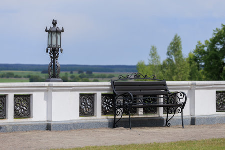 Wooden benches and chaise lounges for rest on the streets of the city and in the park, public placesの写真素材