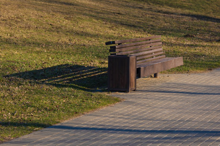 Wooden benches and chaise lounges for rest on the streets of the city and in the park, public placesの写真素材