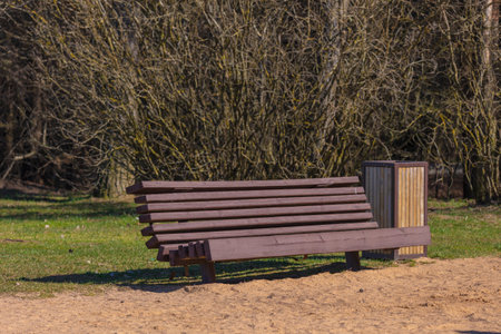 Wooden benches and chaise lounges for rest on the streets of the city and in the park, public placesの写真素材