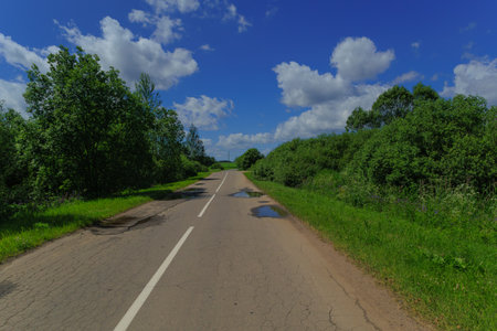 Road view on a summer day. Highways, roadside and white road line markings.の写真素材