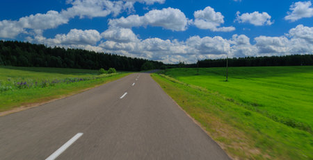 Road view on a summer day. Highways and roadside, white road line markings.の写真素材