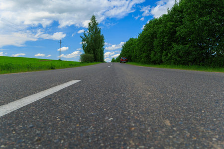 Road view on a summer day. Highways, roadside and white road line markings.の写真素材
