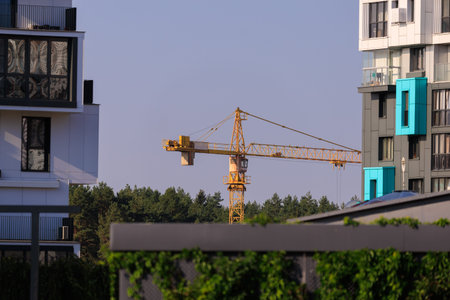 Construction of buildings and high-rise cranes against the sky