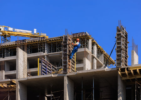 Construction of buildings and high-rise cranes against the sky