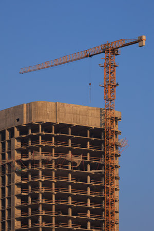 Construction of buildings and high-rise cranes against the skyの写真素材