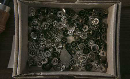 Many rivet of different diameter perfect for leather goods in cardboard box.の写真素材