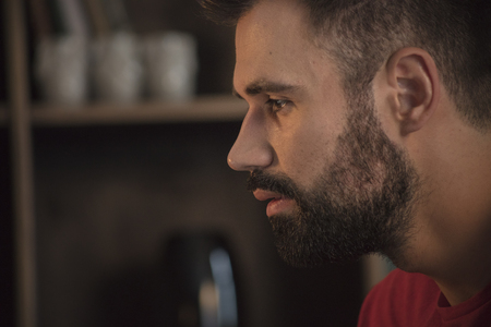Young man face portrait with beard who sad and looking forwardの写真素材