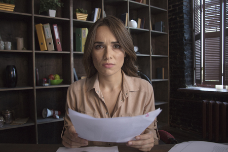Young businesswoman with disappointed look on faceの写真素材