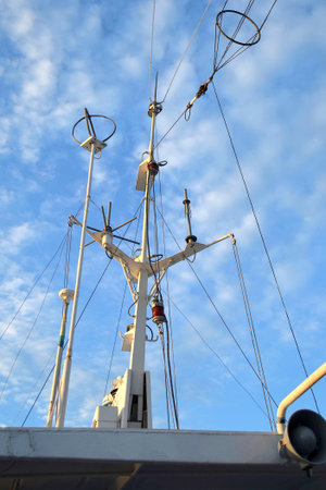 Branched antenna wire of the ship against blue sky