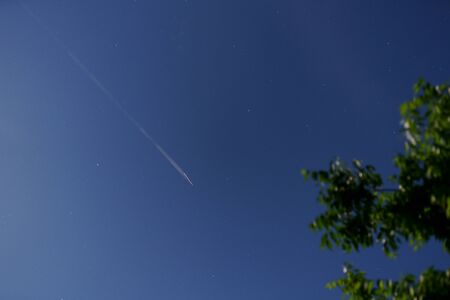 Airplane clouds in the night skyの写真素材