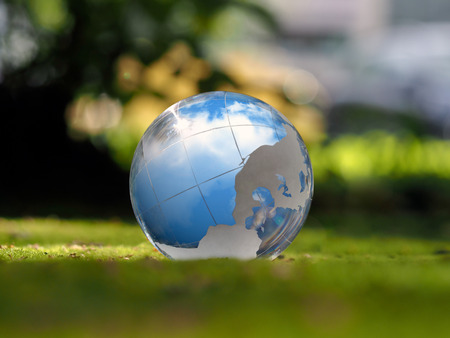 Transparent sphere. Reflection of the sky. Green moss. The concept of ecology, environmental protection, safety, serenityの写真素材