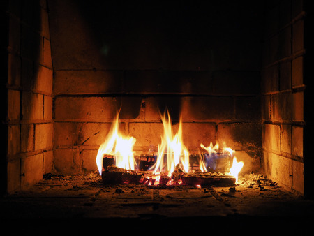 The fire in the fireplace. Firewood, charcoal, flamesの写真素材