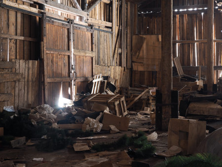 Rubbish, garbage in an old wooden barn. Rays of lightの写真素材