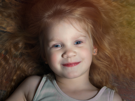 Portrait of a little girl with luxurious blond hairの写真素材