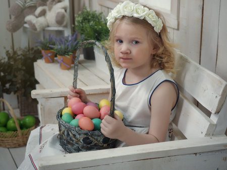 Little child girl with basket of Easter eggs