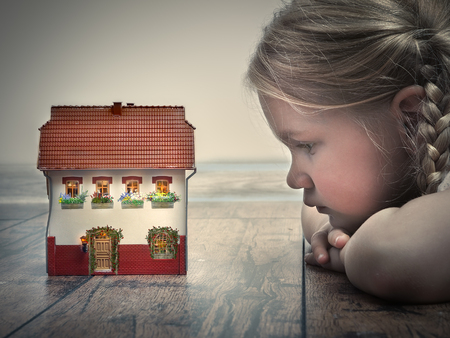little girl dreams of a country houseの写真素材