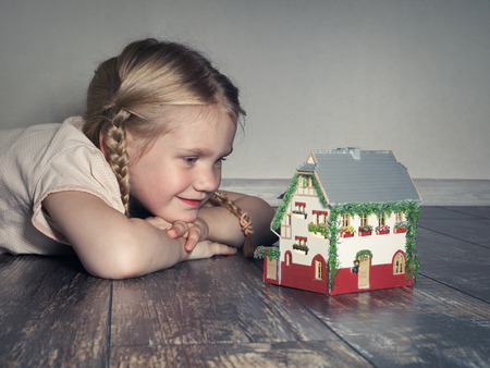 little girl dreams of a country houseの写真素材