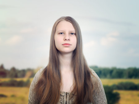 Beautiful young girl on the background of field and sky. Russian beauty