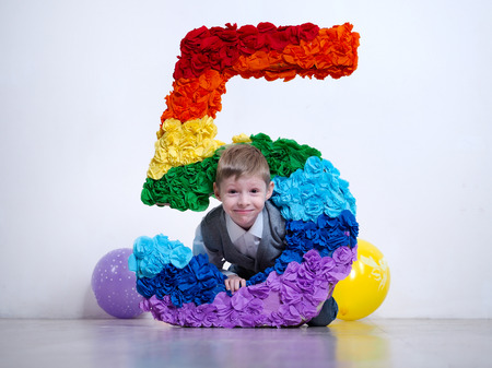 Portrait of happy boy's birthday. A huge number five. The birthday celebrationの写真素材