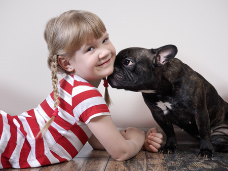 Very funny dog and a little girl. The relationship of a pet with a childの写真素材