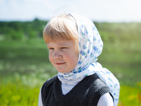 little Russian girl in kerchief. Portrait of a village childの写真素材