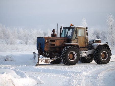 Tver region. Sonkovsky district. Russia. 28 January 2019. Clearing snow from the road. Tractor...