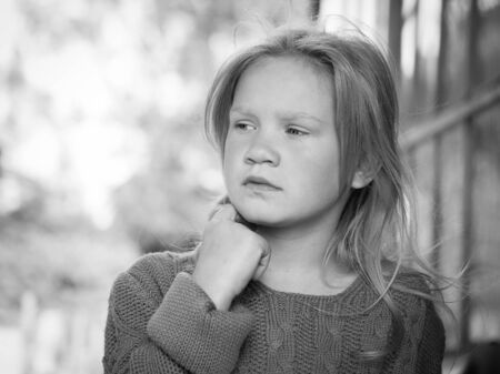 Portrait of a girl. The child looks away thoughtfully. Beautiful face and hairの写真素材