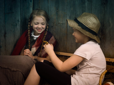 Village children in the hayloft looking at a butterflyの写真素材