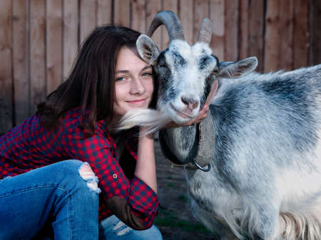 Portrait of a girl with a goatの写真素材