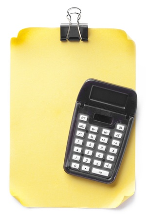 Yellow sheet and calculator on a white backgroundの写真素材