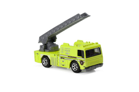 Isolated image of green toy fire truck extending its ladder