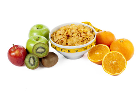 Fruits and corn flakes bowl on a close up image isolated on