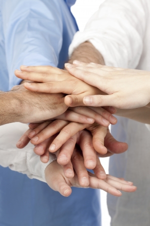 Close up image of group of business people overlapping handsの写真素材