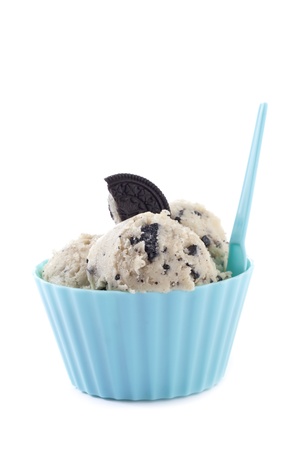 Cookies 'n Cream flavored ice cream with chocolate biscuit on top on a blue cupの写真素材