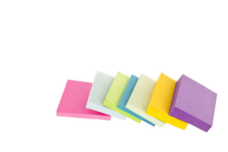 Assorted piles of  sticky note pads laid in a white background