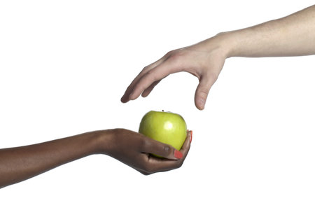 Close-up image of a hand taking an apple from the other hand